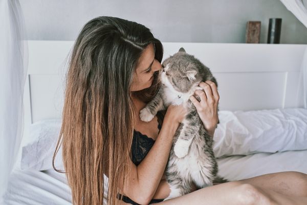 Woman cuddling her cat